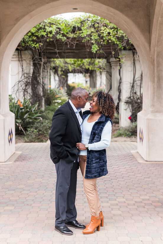 parents hugging under arch san diego