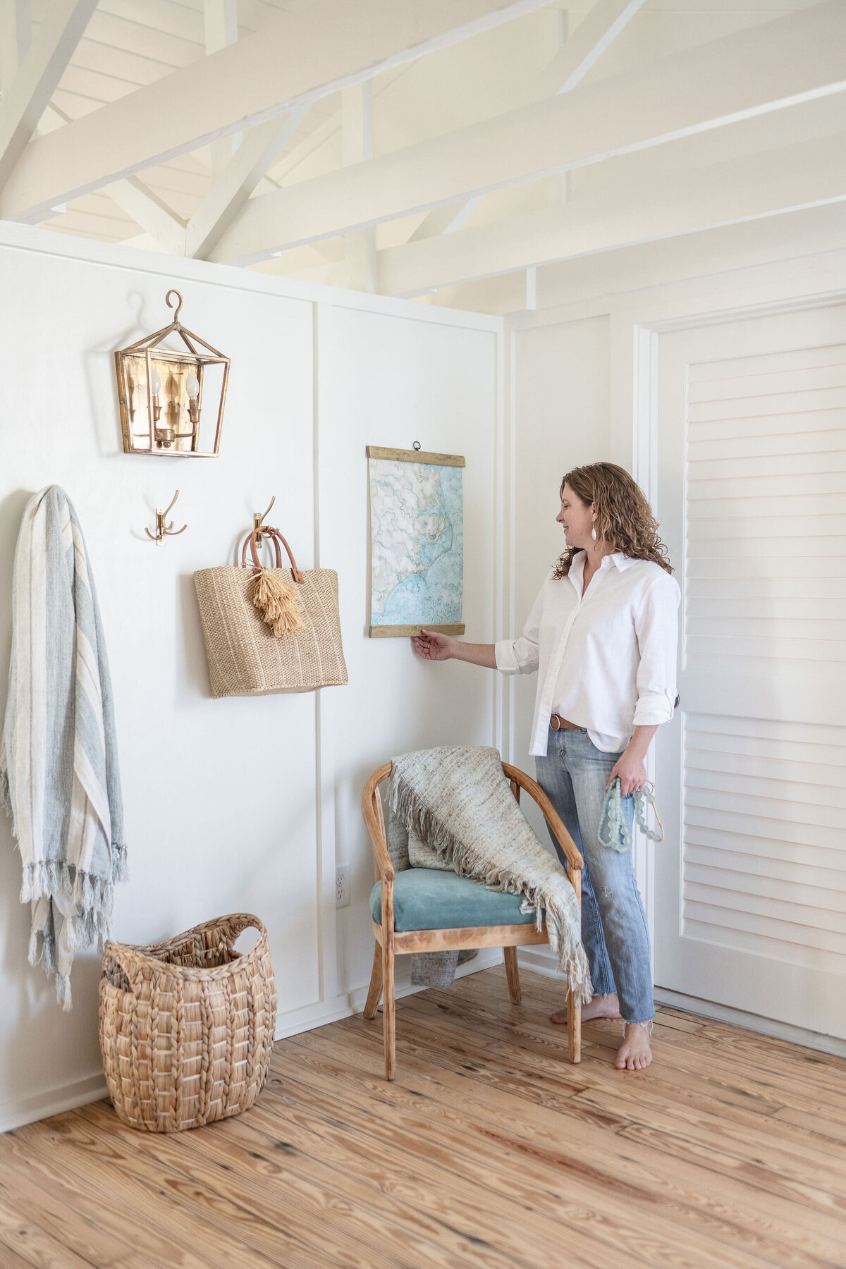 watercolor artist hanging a piece of art on the wall