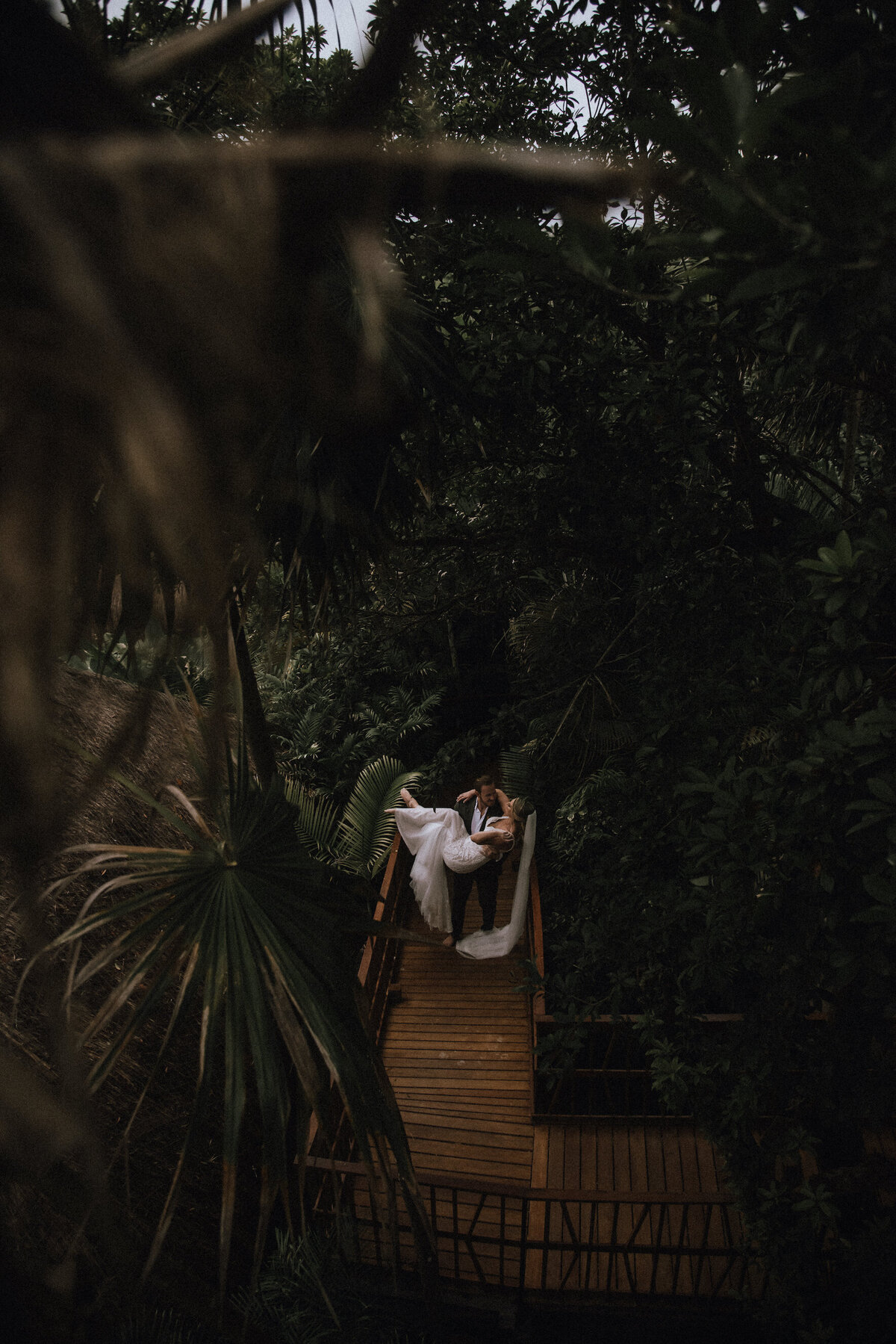 Groom sweeps the bride off her feet at their destination wedding in Villa Amaite Tulum Mexico.
