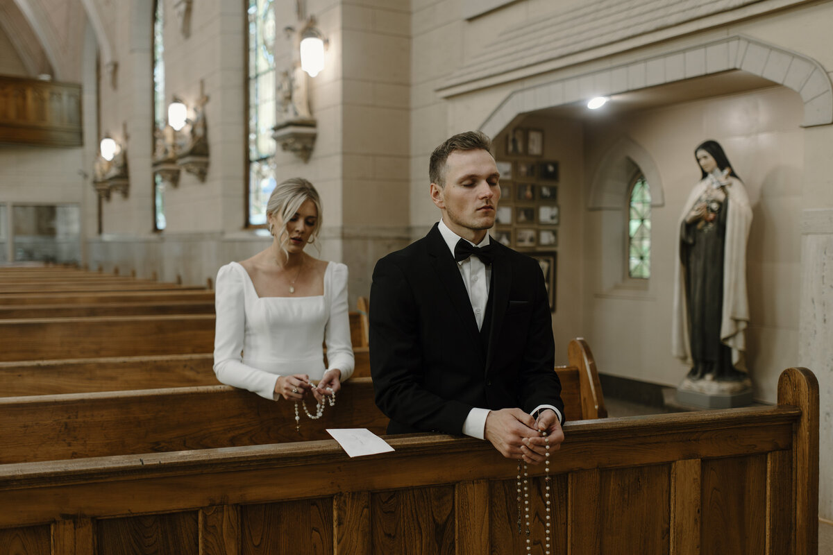 bride and groom praying a rosary