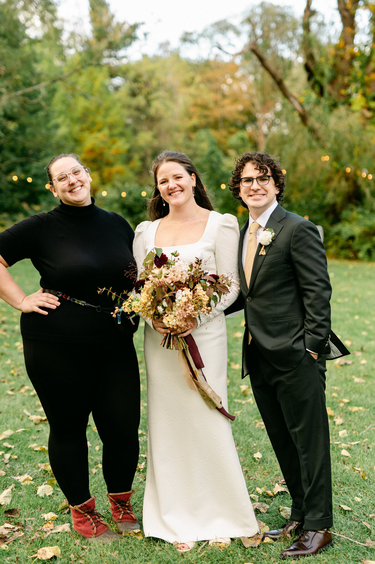 Rachel smiling with bride and groom she helped with their wedding