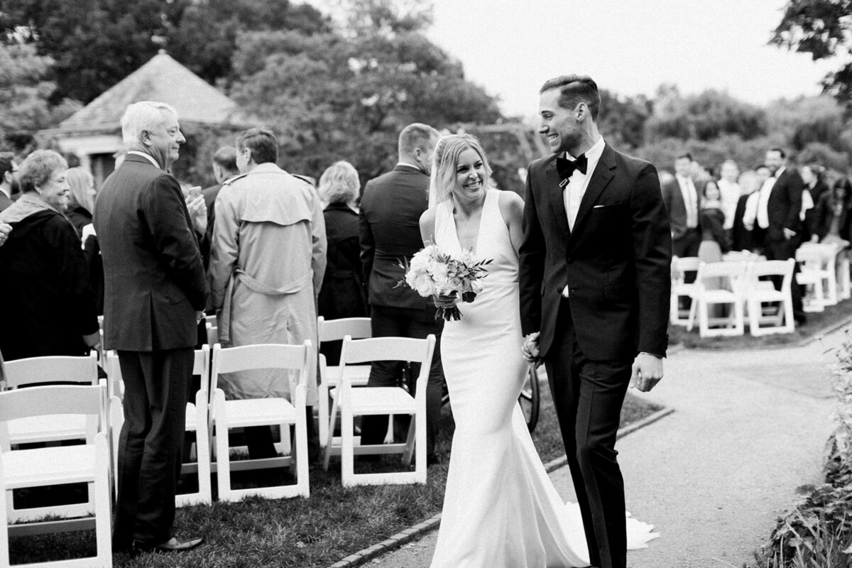 Bride and groom walk back down the aisle after the ceremony at a luxury Chicago outdoor garden wedding.