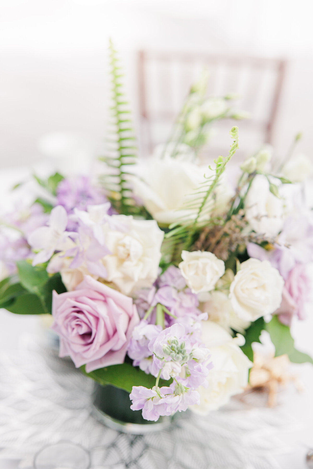 Close up of white and purple floral centerpieces during a Tower Hill wedding reception