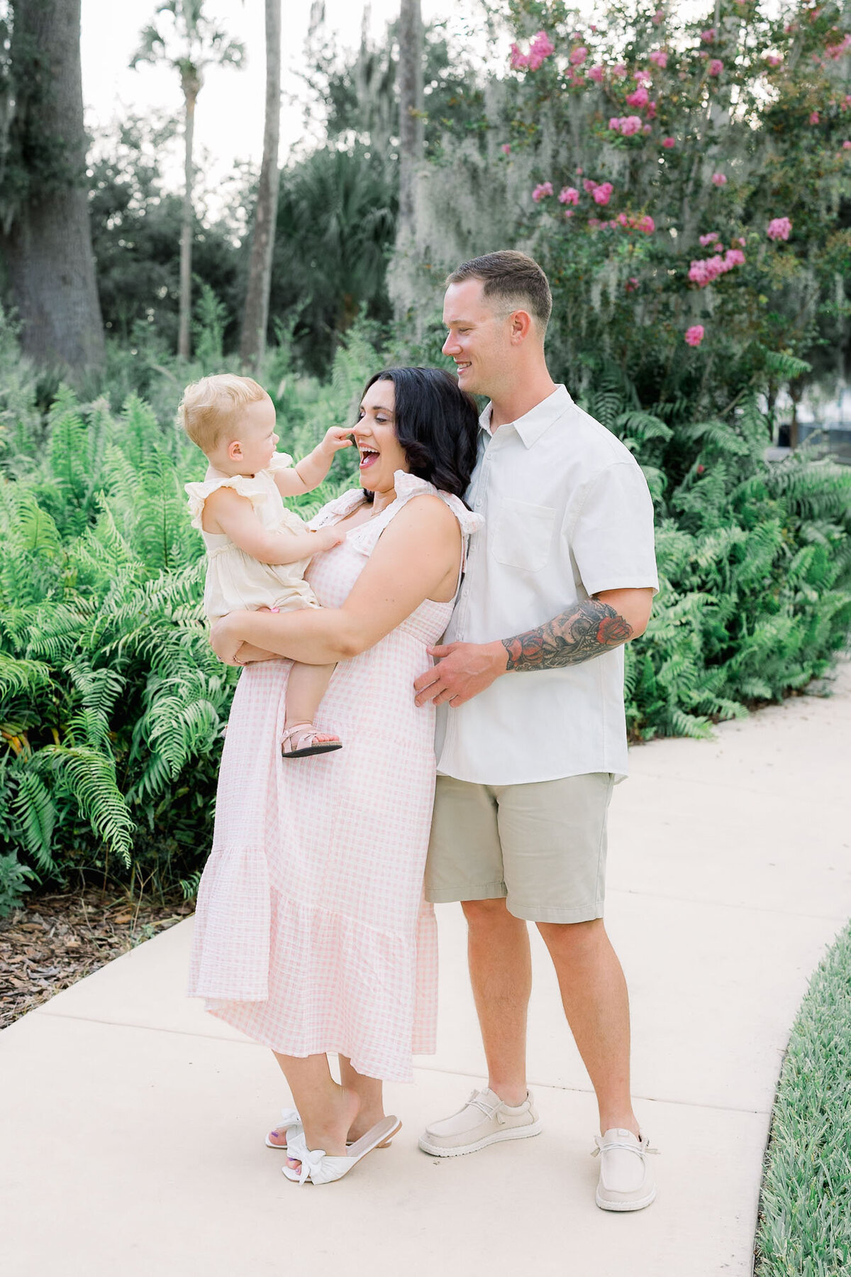 Pregnant couple with mom holding toddler in park for Tampa maternity photographer Tina Marie Studio.