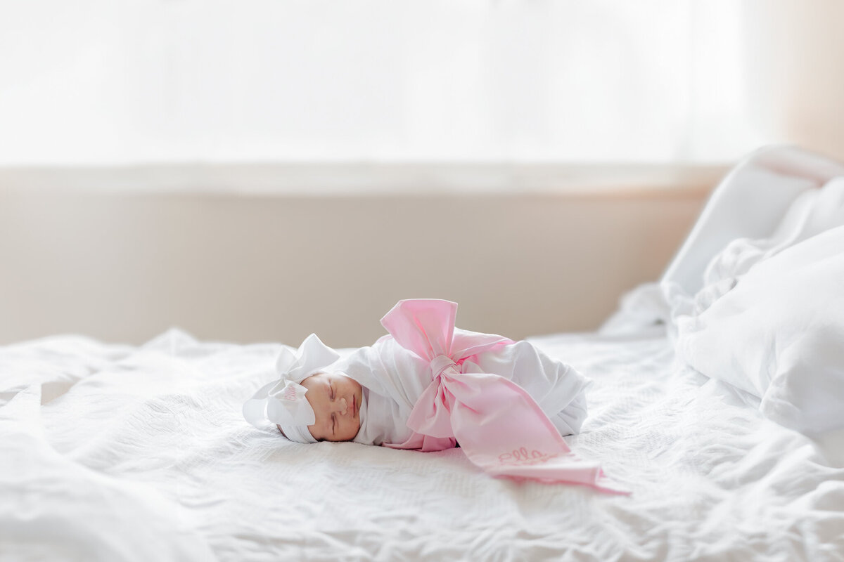 Newborn baby peacefully sleeping in a hospital crib, wrapped in a soft white blanket