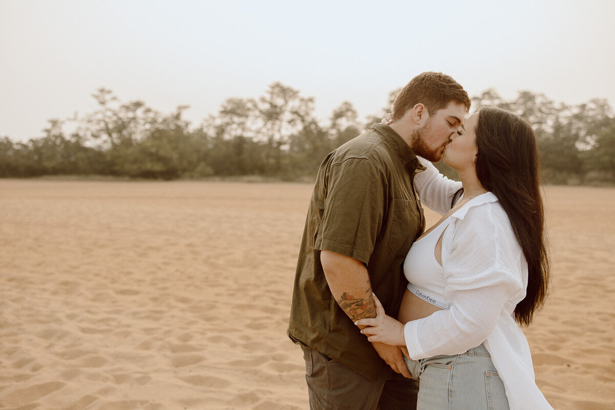 Couple embraces and kisses on the beach
