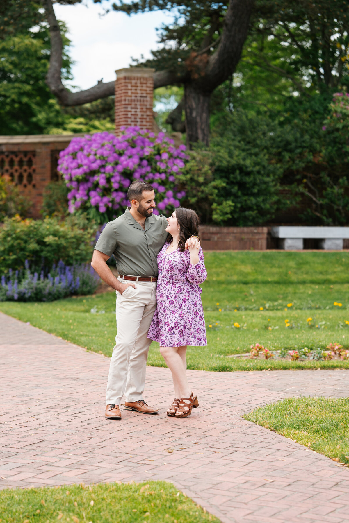 Couple walking through the rose garden at Lynch Park during their Beverly engagement session with Danielle Littles Photography