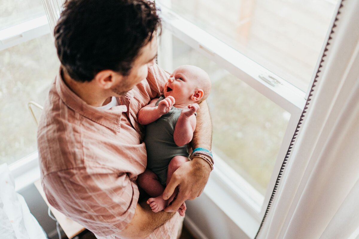 seattle-dad-holding-his-newborn-son-at-home