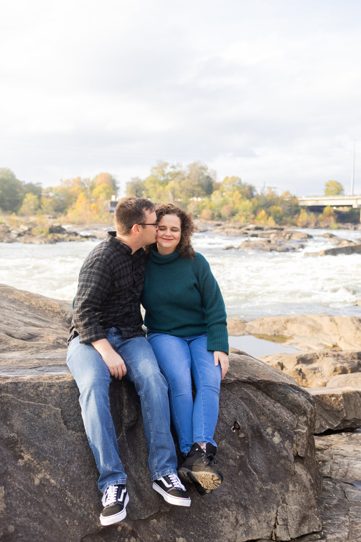 engaged-couple-sitting-along-waterfront-columbus-georgia