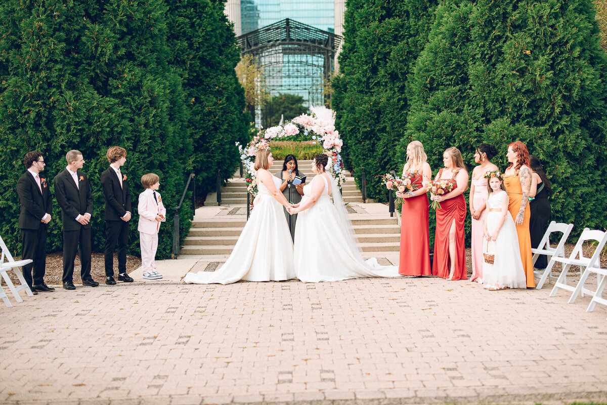 A queer couple has their wedding ceremony in the Cancer Survivors Garden at Maggie Daley Park