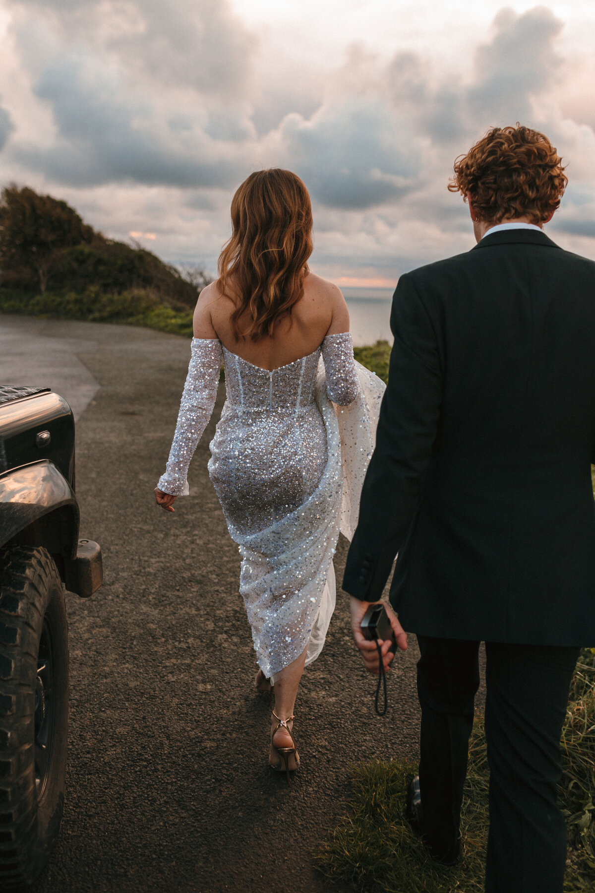 Couple portraits before sundown at winter wedding by the sea