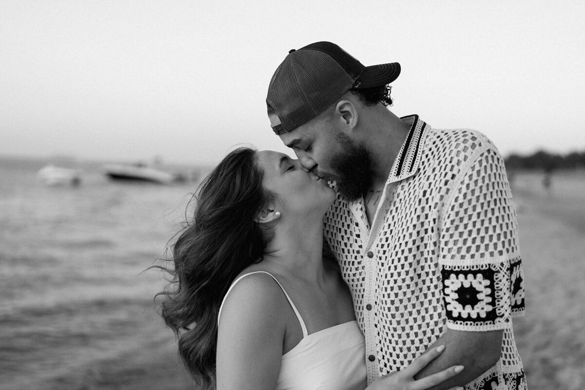Couple dancing and spinning in the sand during their New Buffalo Beach engagement session at sunset