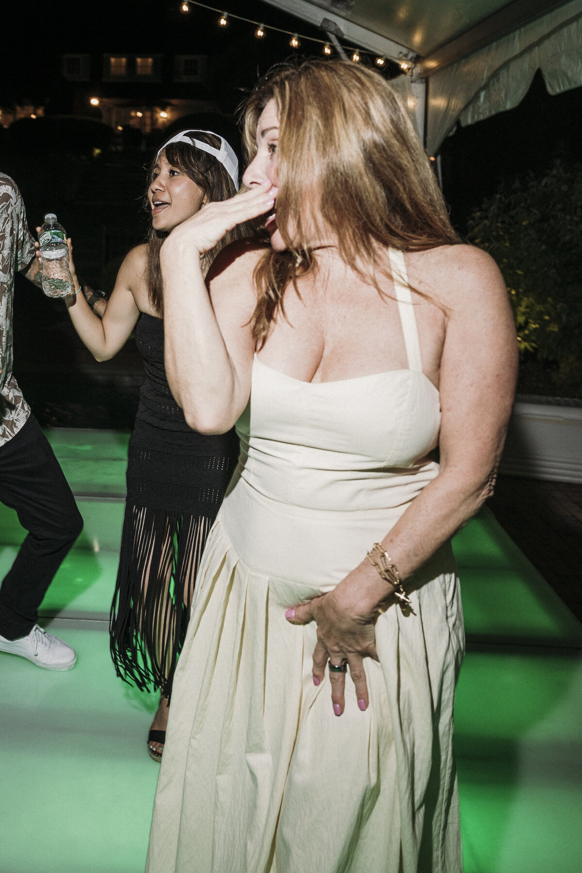 Photo of guests dancing on neon green dance floor in private backyard party by Mira Park Photography NY based wedding photographer