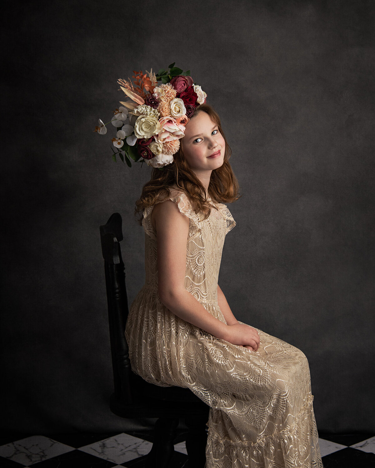 Fine Art Portrait of a girl with a large flower crown and a small smile