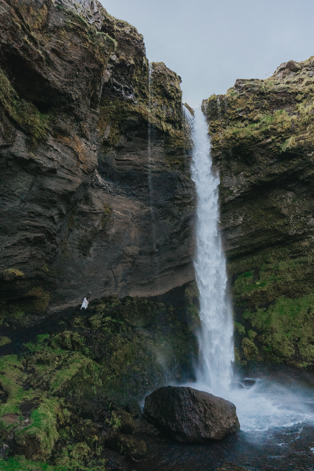 The couple enjoys a peaceful walk by a secluded waterfall