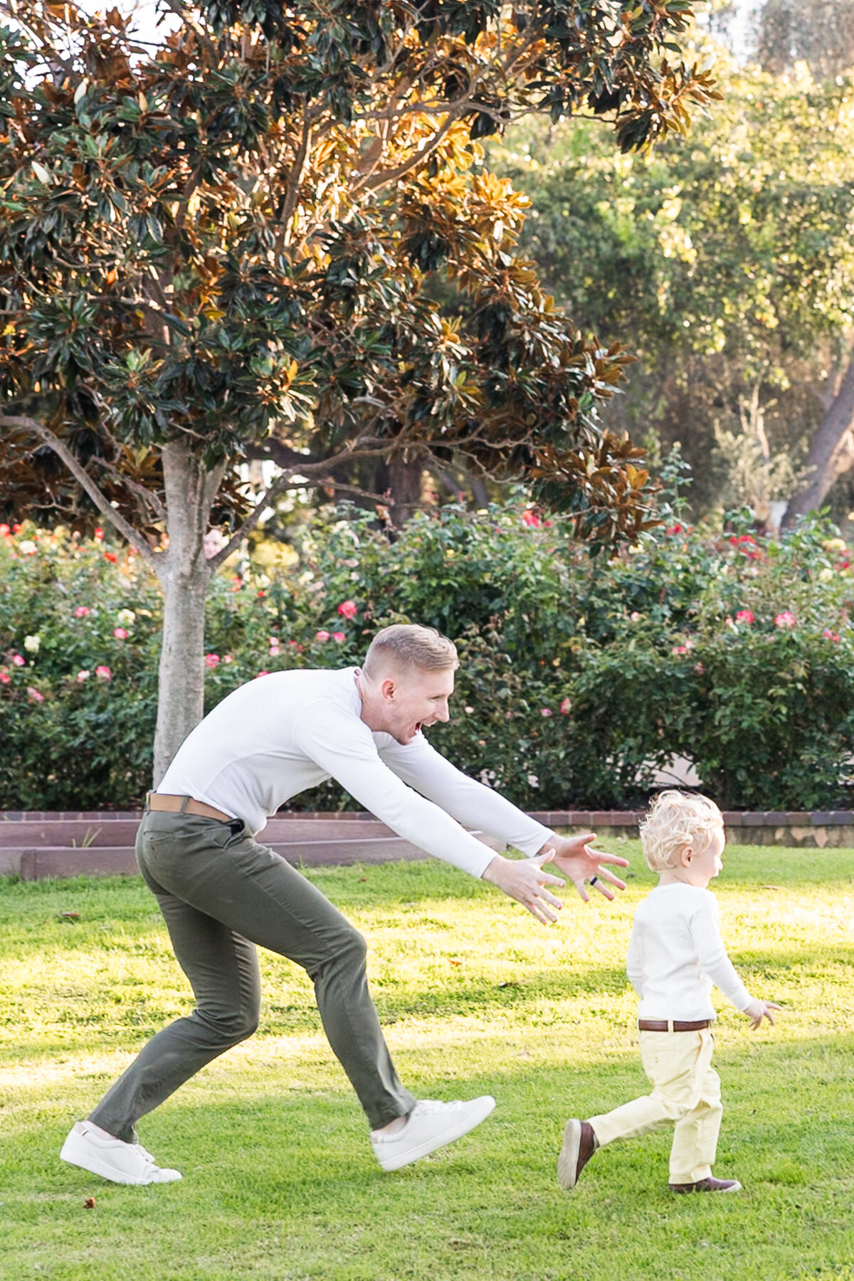 father chasing son in san diego park