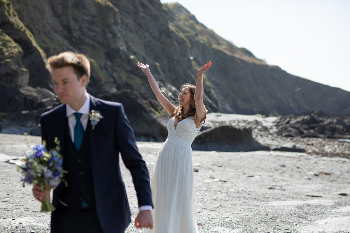 Bride and groom on the beach at Tunnels Beaches wedding venue in Devon