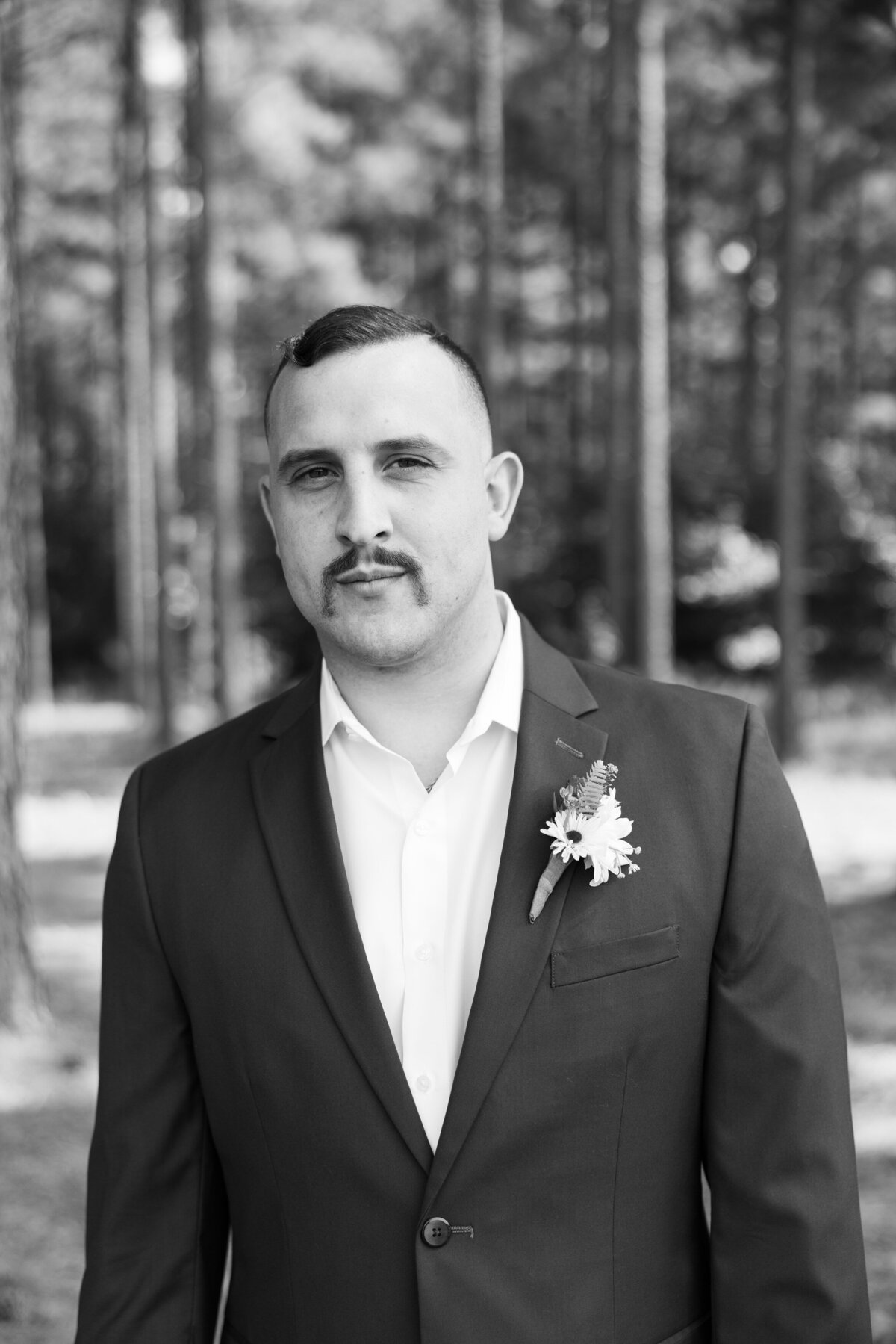 Black and white photo of a man in a suit looking serious