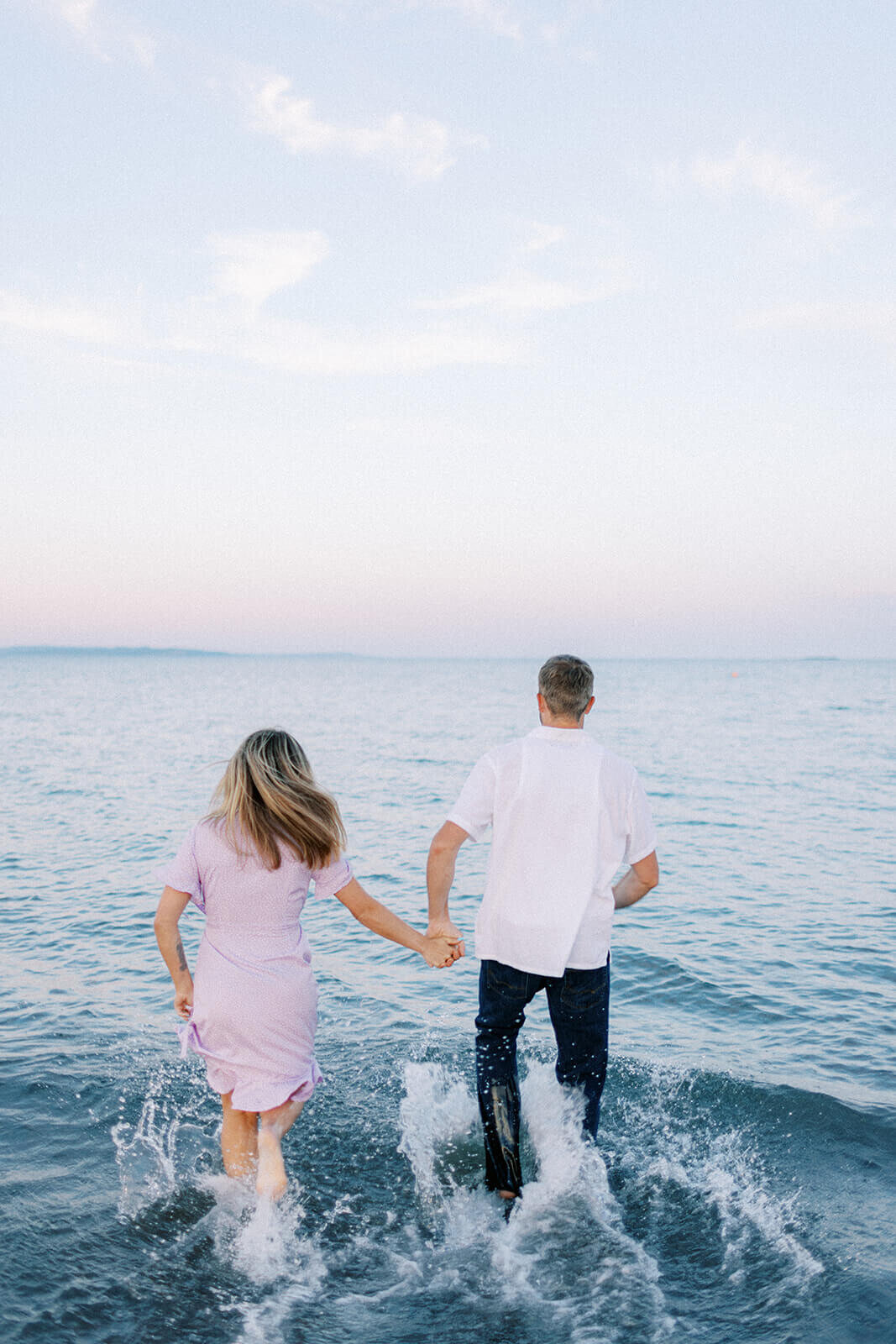 man-and-woman-run-in-water