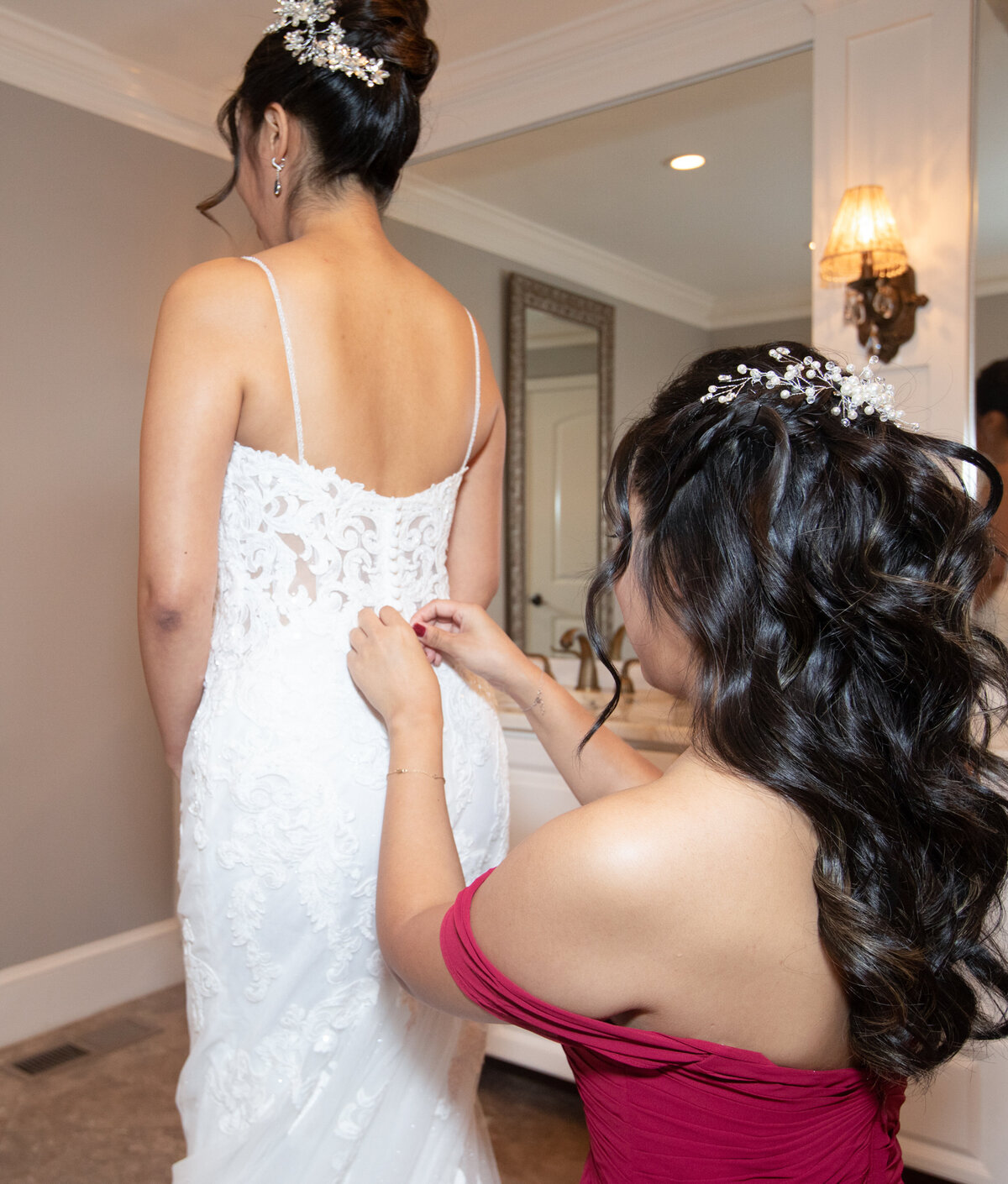 Bridesmaid-Helping-Bride-with-Dress-Tate-Hous