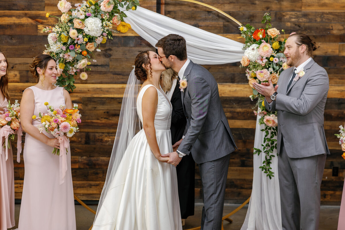 Bride and groom's first kiss as married couple, Market Hall Raleigh ceremony