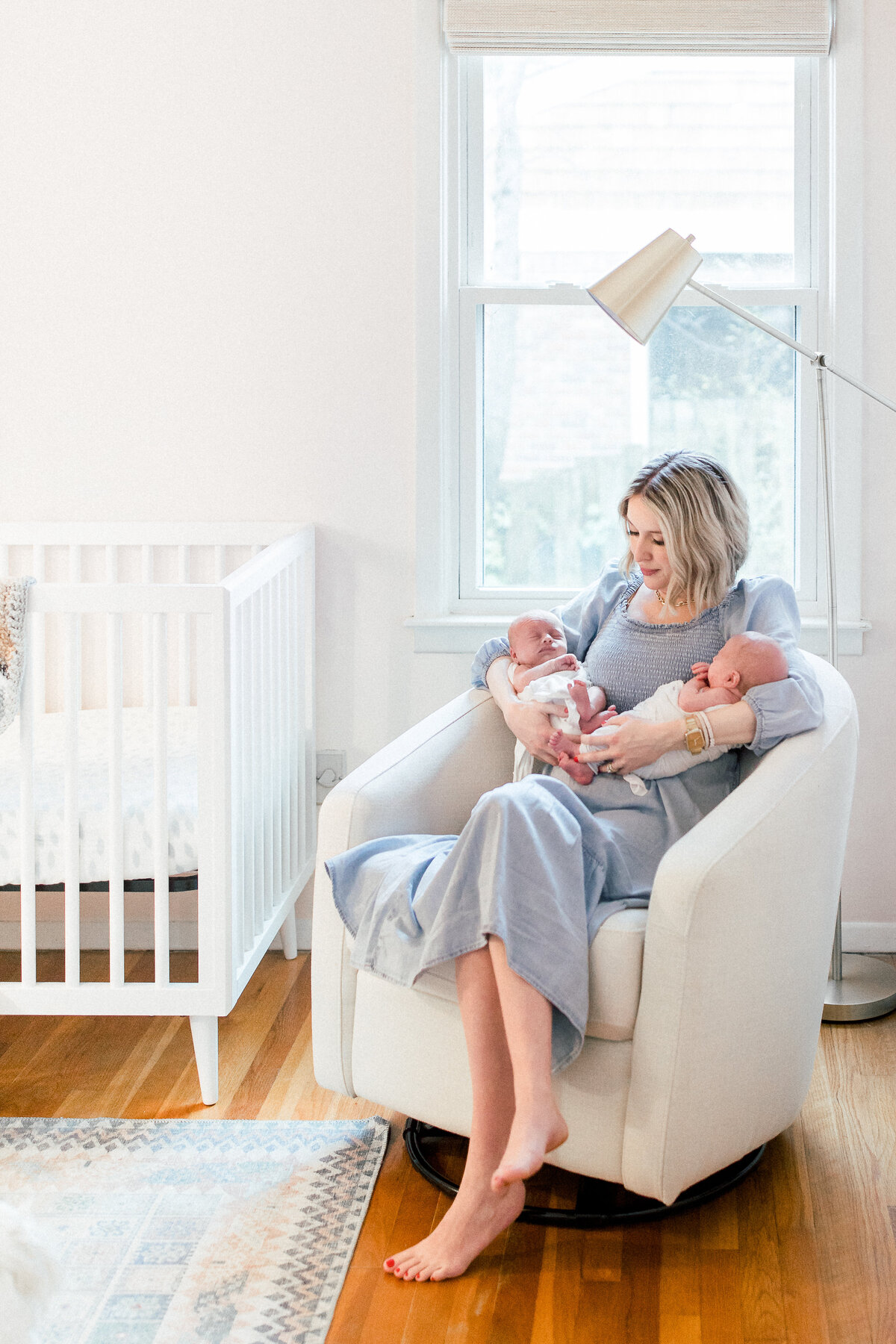 Brookhaven newborn twin photographer - mom holding twins in chair