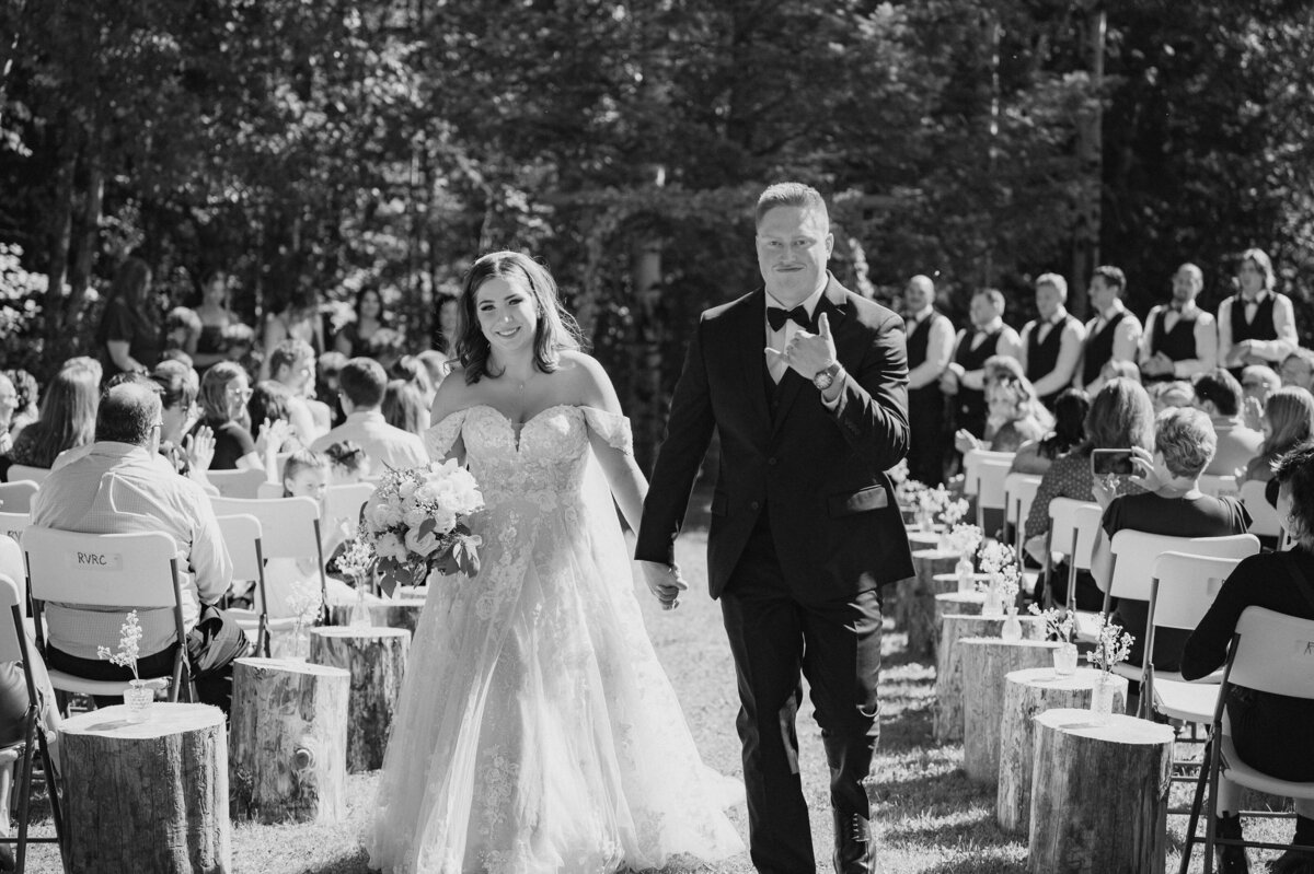 bride and groom walking down the aisle after officially becoming husband and wife