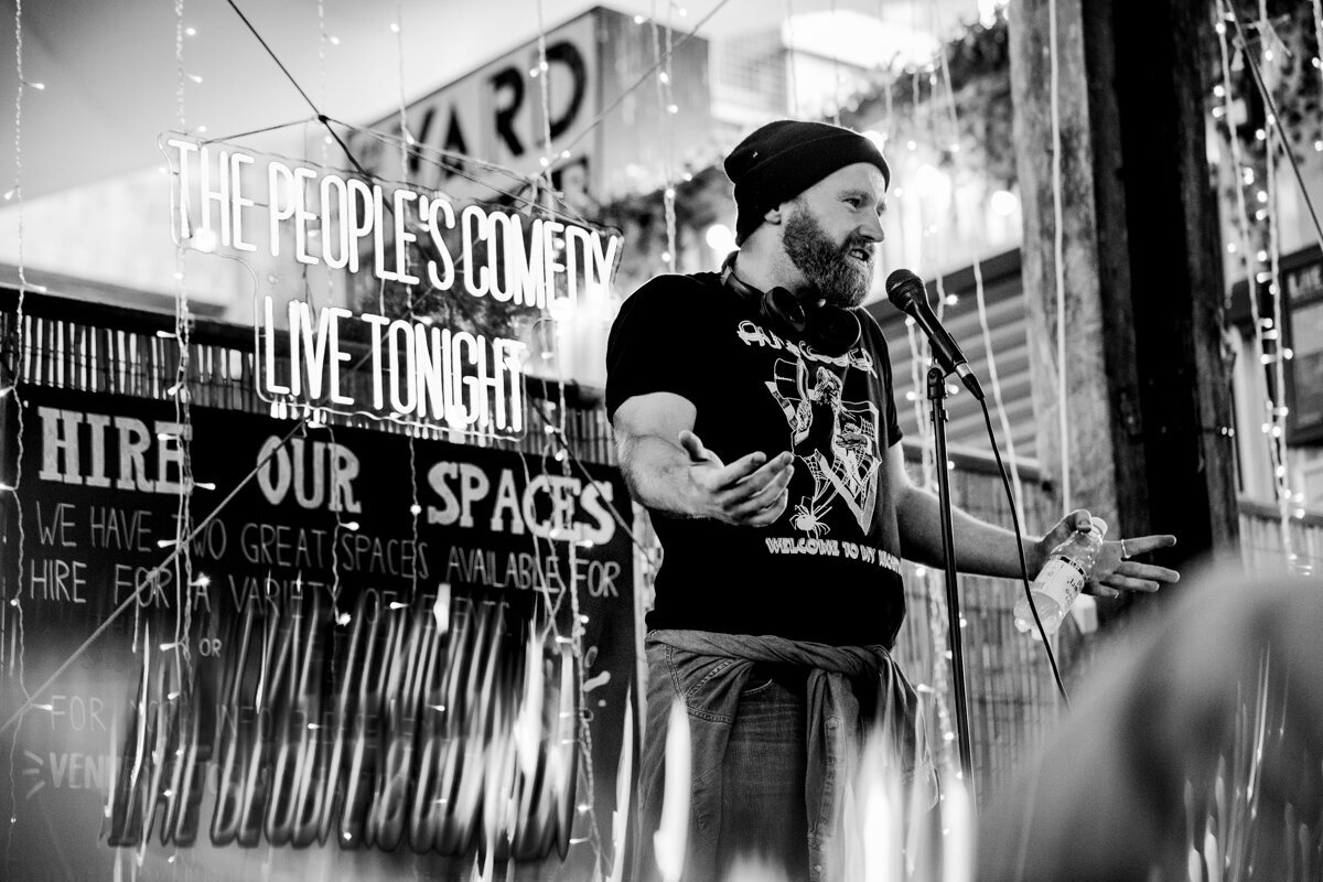 a person branding photograph of a woman with curly hair holding a cup of tea surrounded by plants