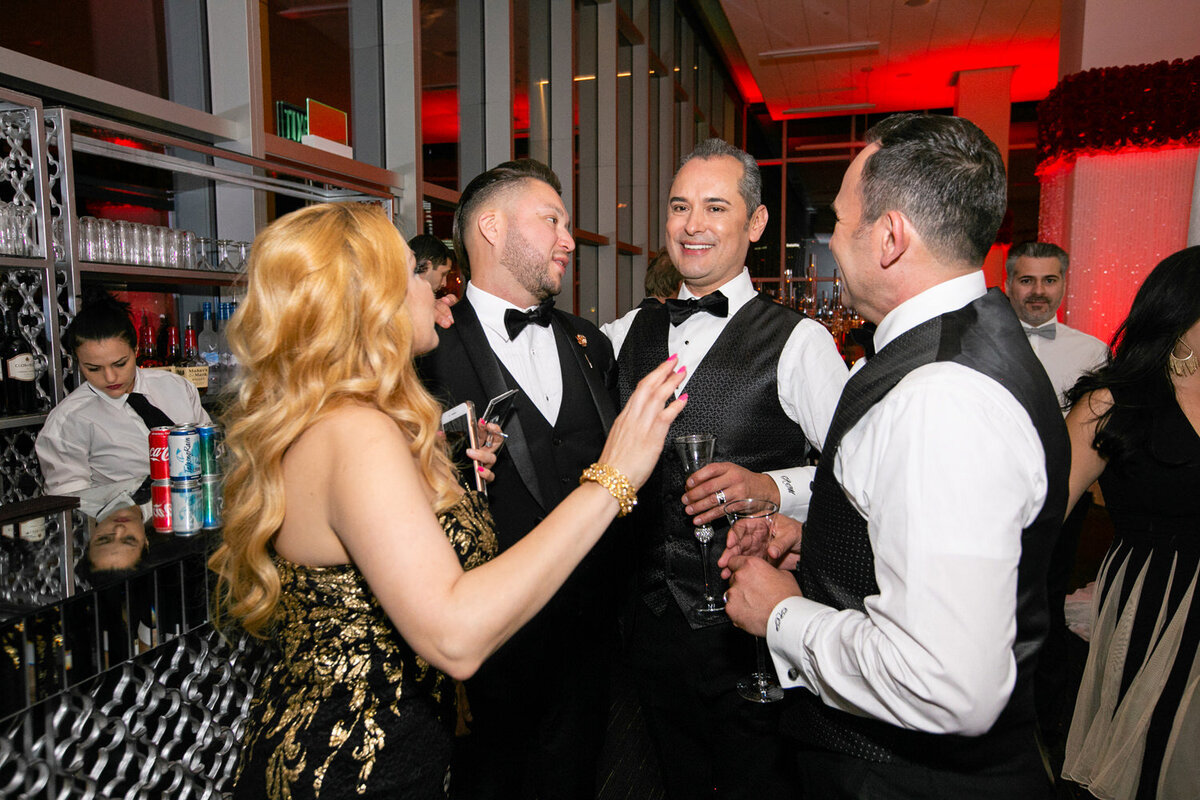 Wedding guests laughing and talking to grooms