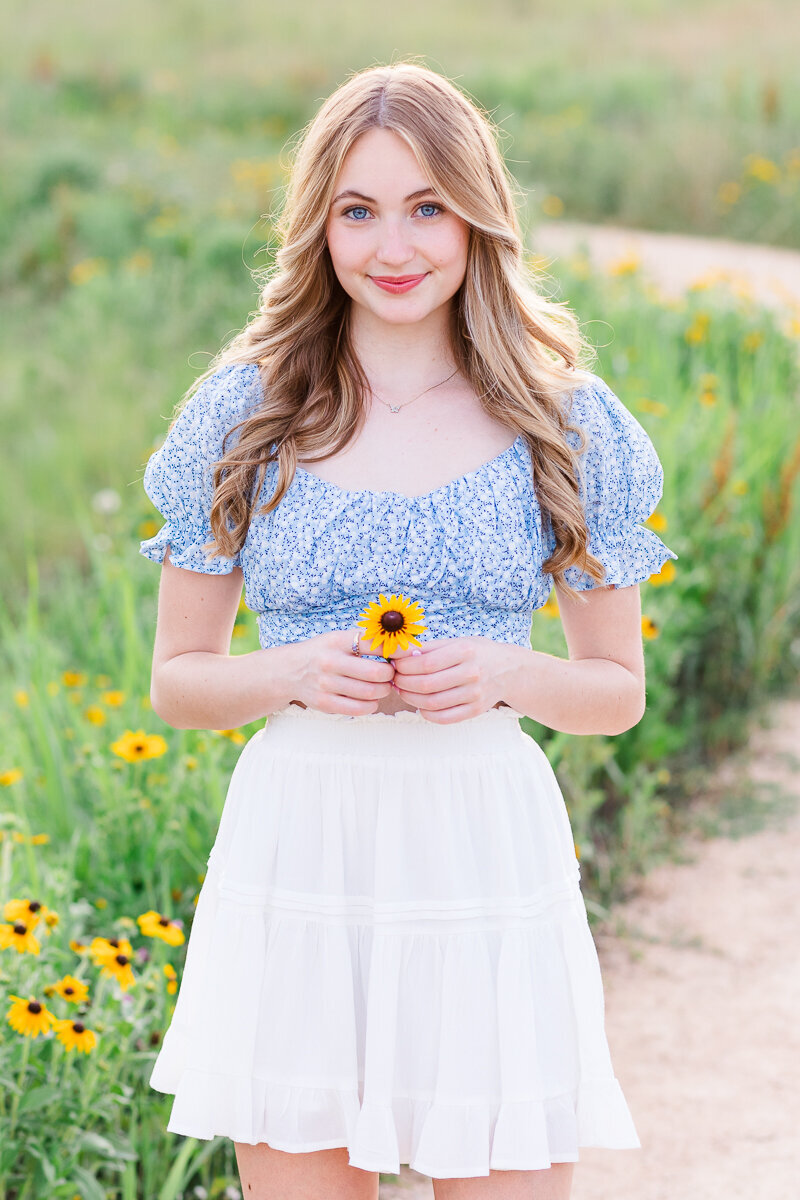Senior girl in a sunflower field.