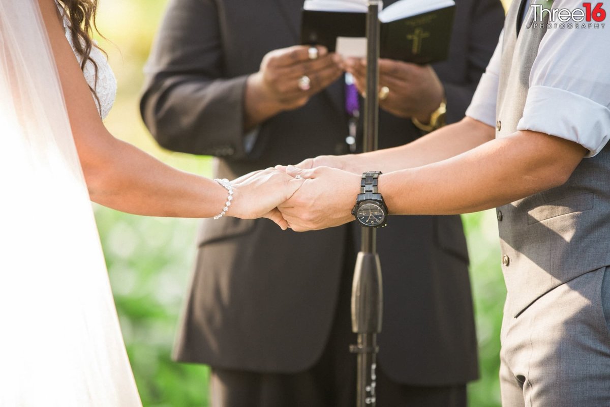 Bride and Groom holding hands during ceremony