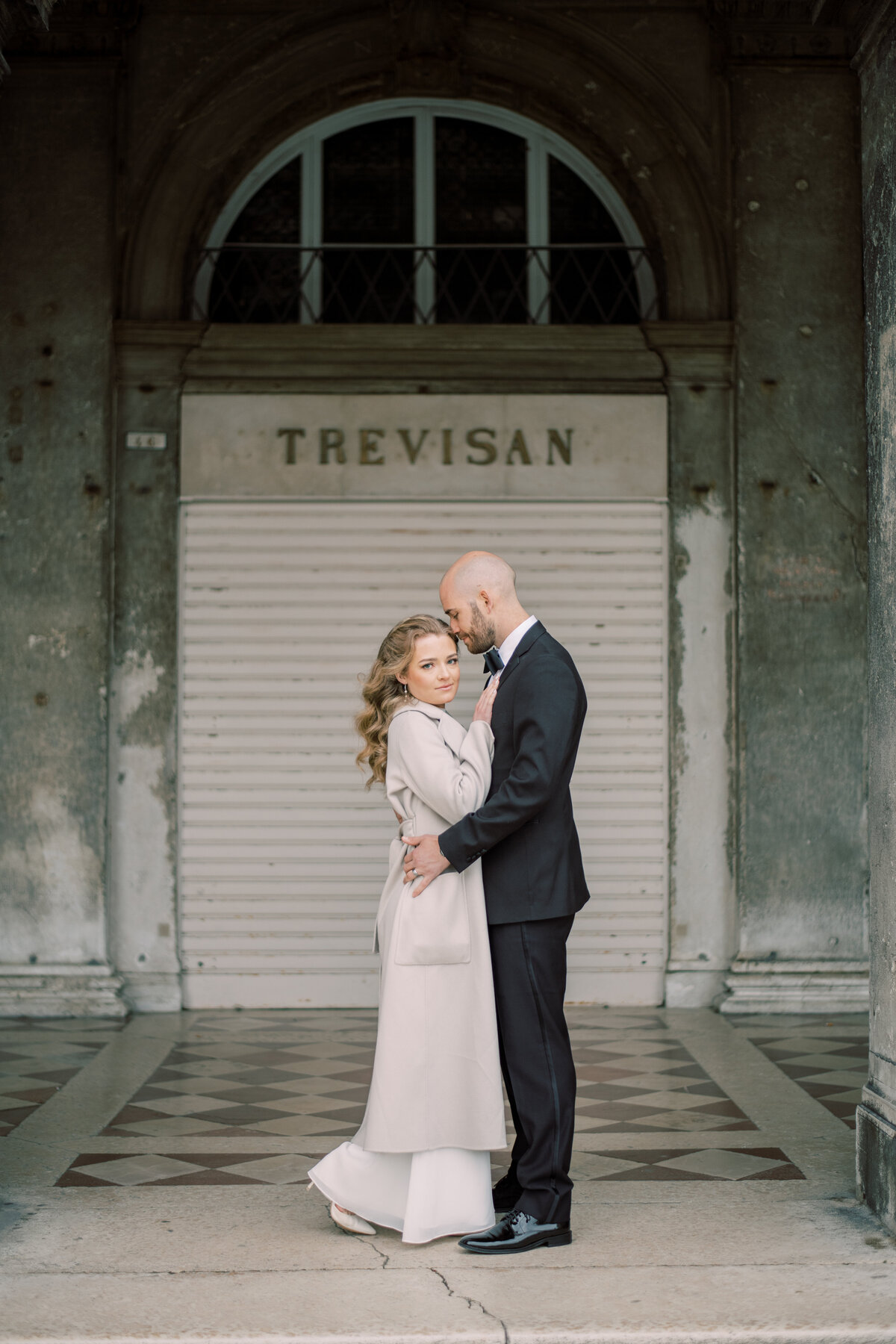 Couple in Venice Italy, man hold woman but she looks away 