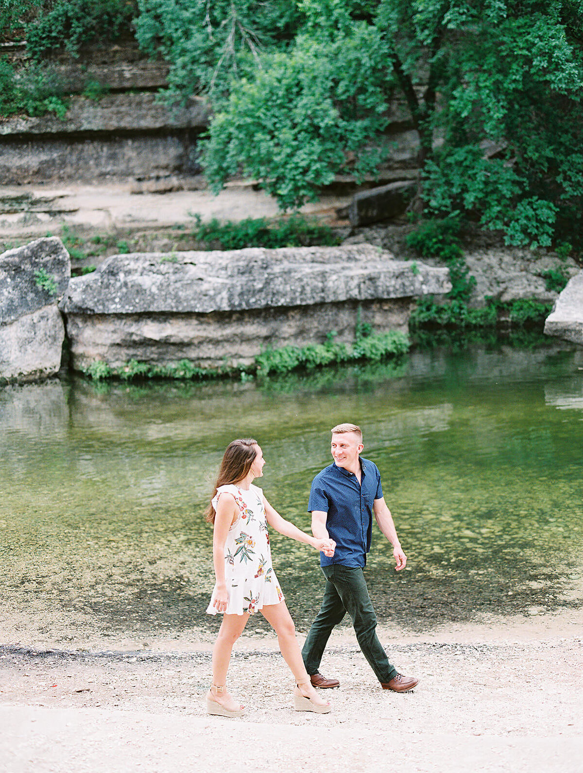couple walks hand in hand past the natural rock formations at Bull Creek