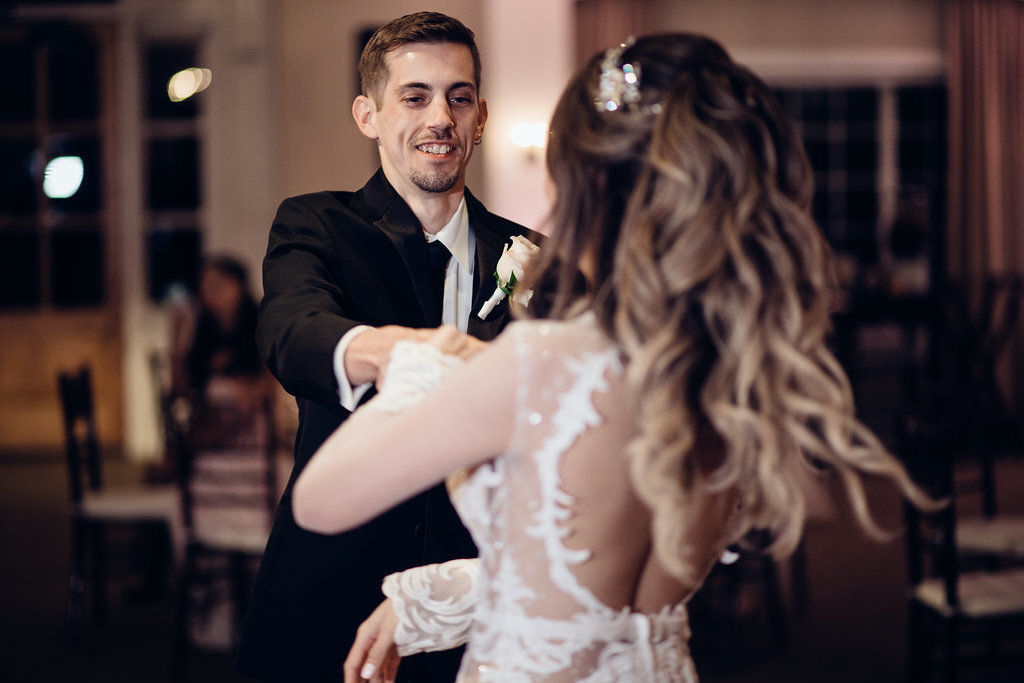 Wedding Photograph Of Bride And Groom Extending Their Arms While Dancing Los Angeles