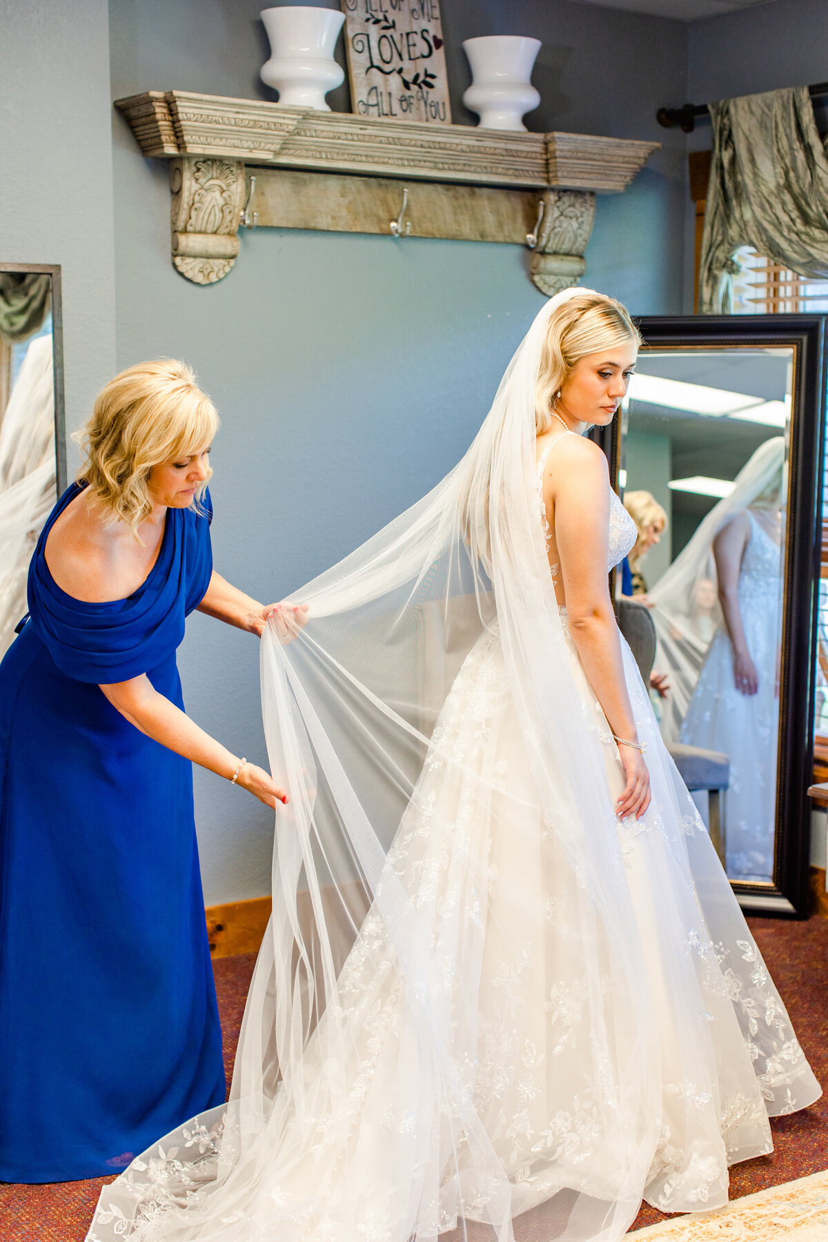 bride's mom helping her with her wedding dress at Laurel Ridge Country Club
