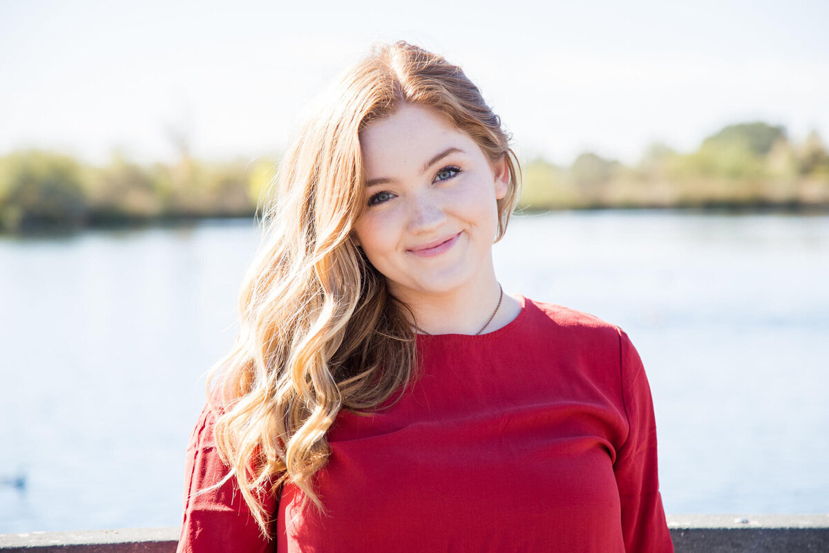 brightly lit portrait of a redheaded senior girl