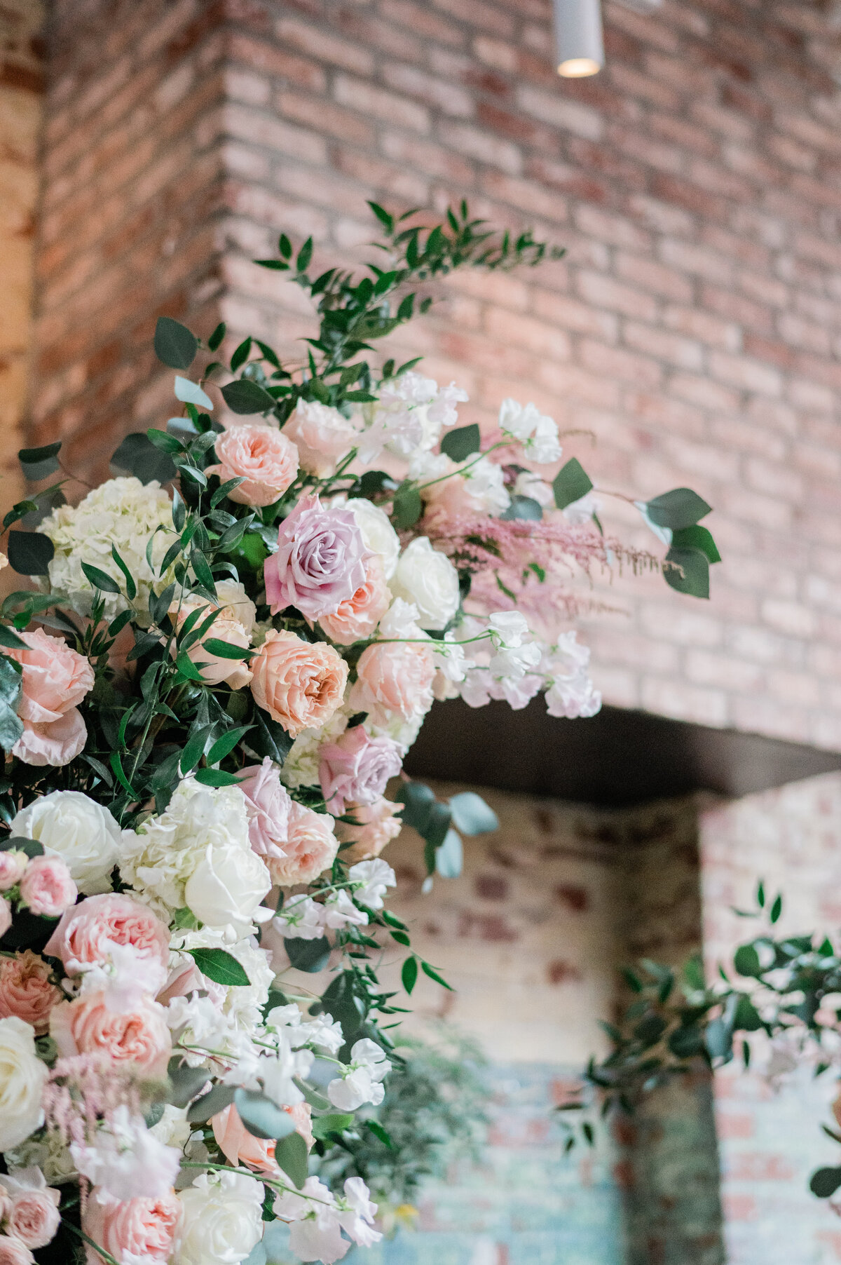 Floral arches on a rustic brick building