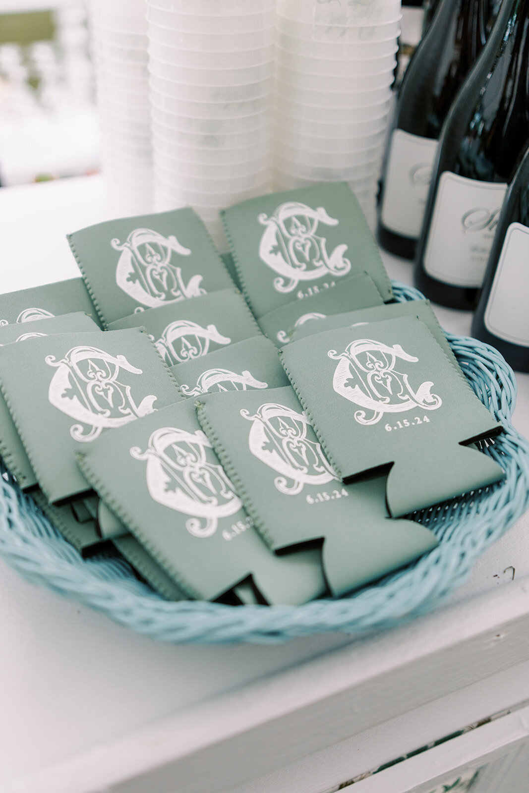 Close up of custom crest wedding koozies. 