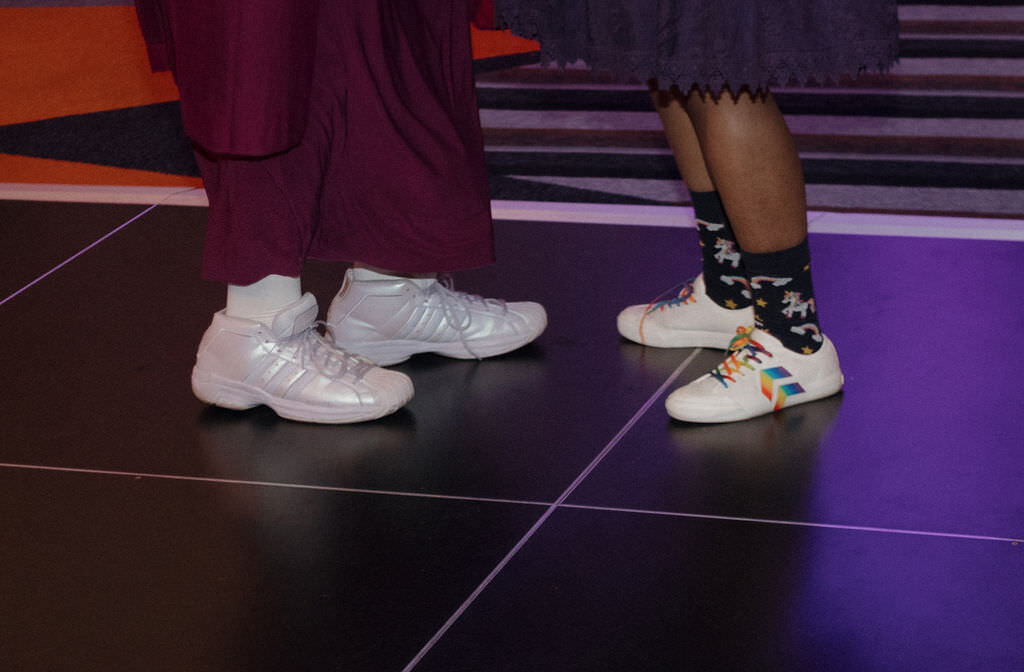 A close up of two people's shoes.