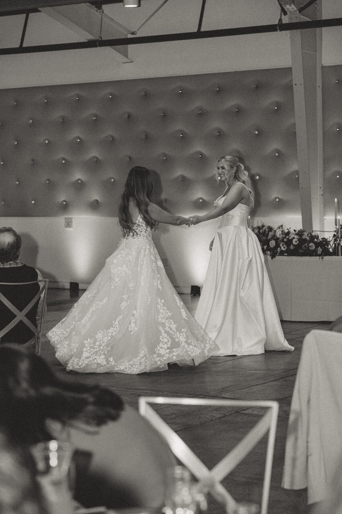 two-brides-first-dance-lace-twirl-black-white