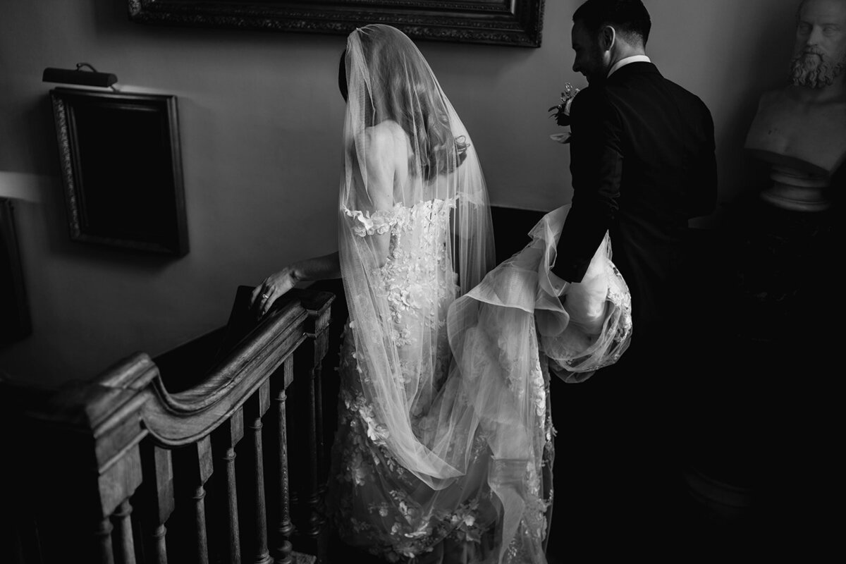 Black on my photograph of the bride and groom walking down the stairs in the main house