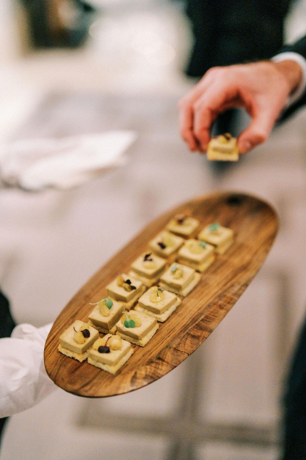 Close up photo of the appetizers on a wooden tray. 