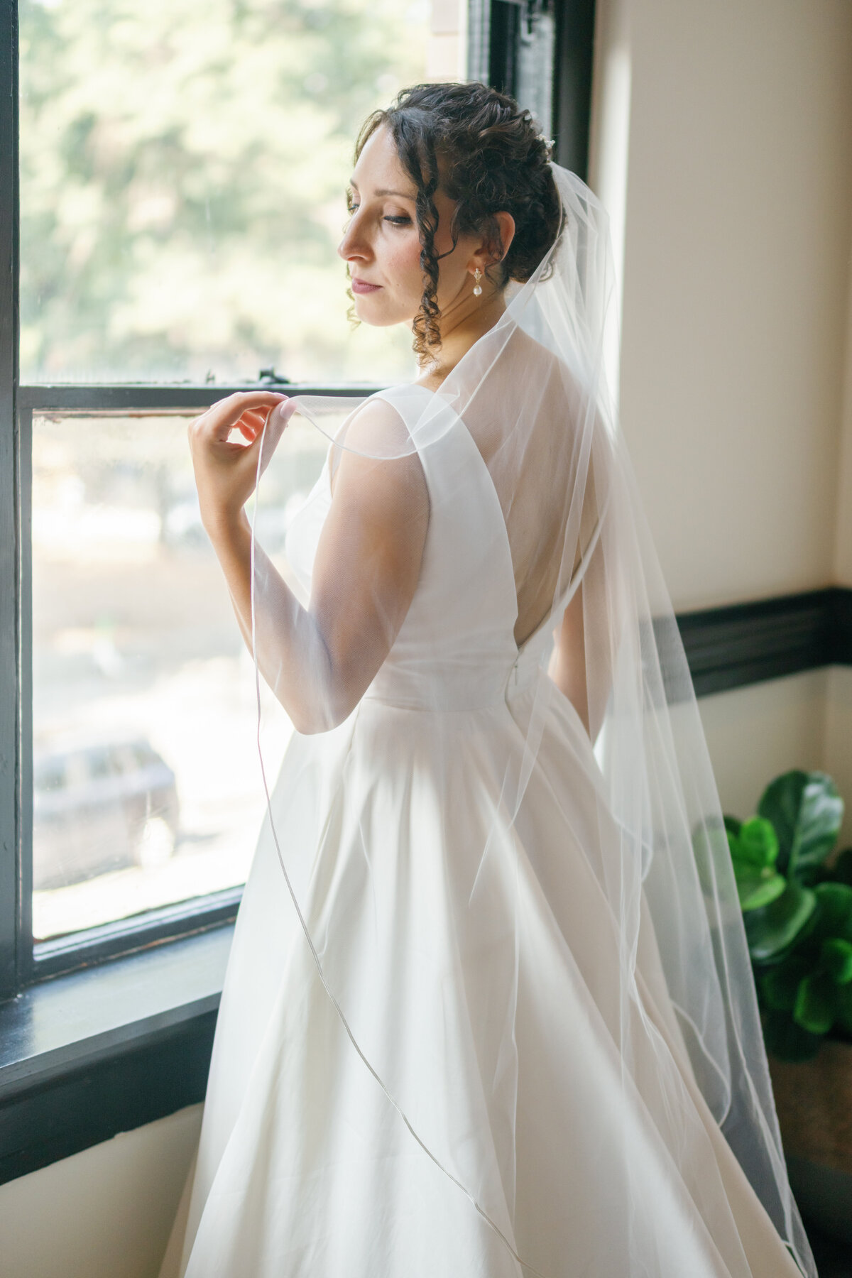 Close-up of bride in wedding gown, natural light portrait at Market Hall Raleigh
