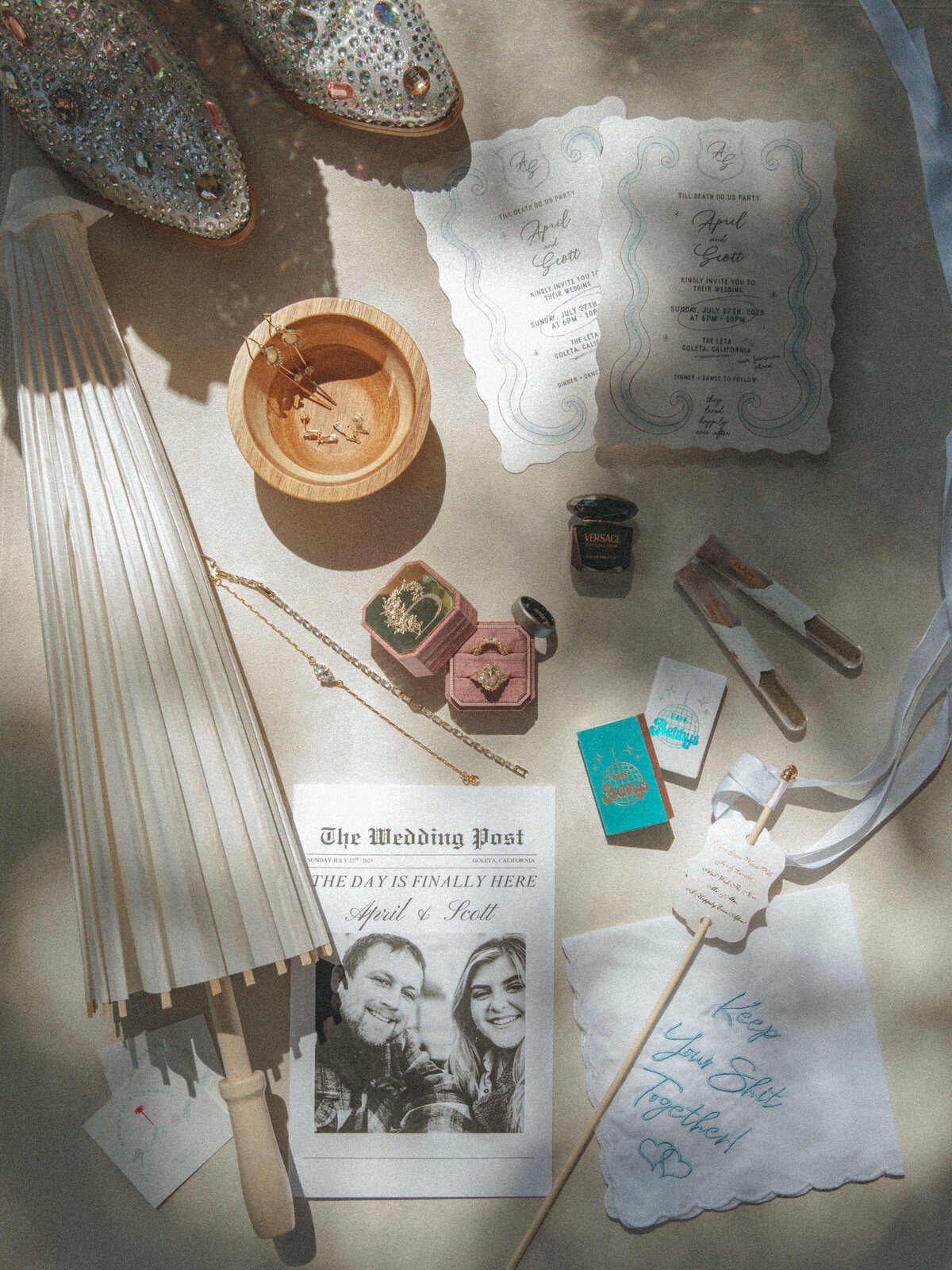 a wedding flat lay with all of the bride's wedding details and wedding favors for guests