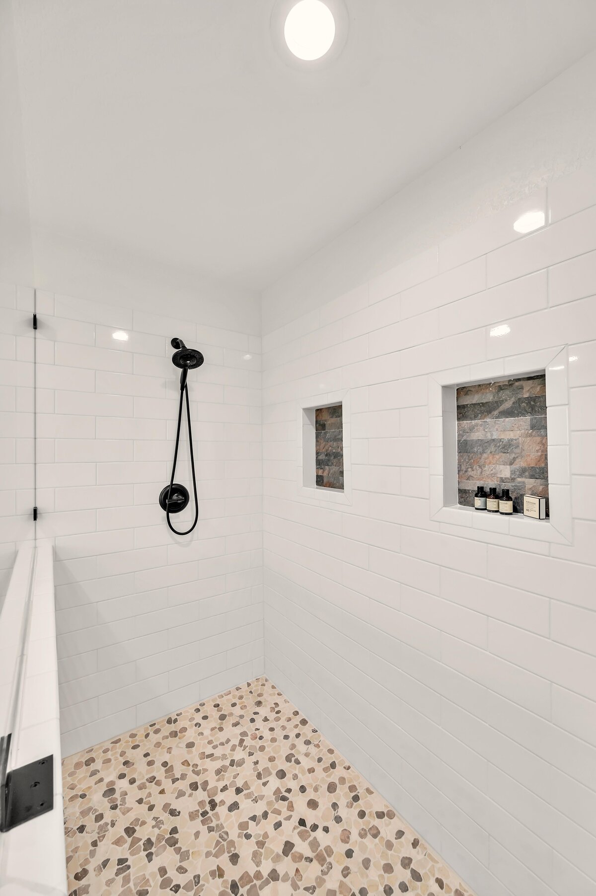 Large walk-in shower in the bathroom of this three-bedroom, two-bathroom vacation rental house with free Wifi, fully equipped kitchen, office space, and room for six in downtown Waco, TX.
