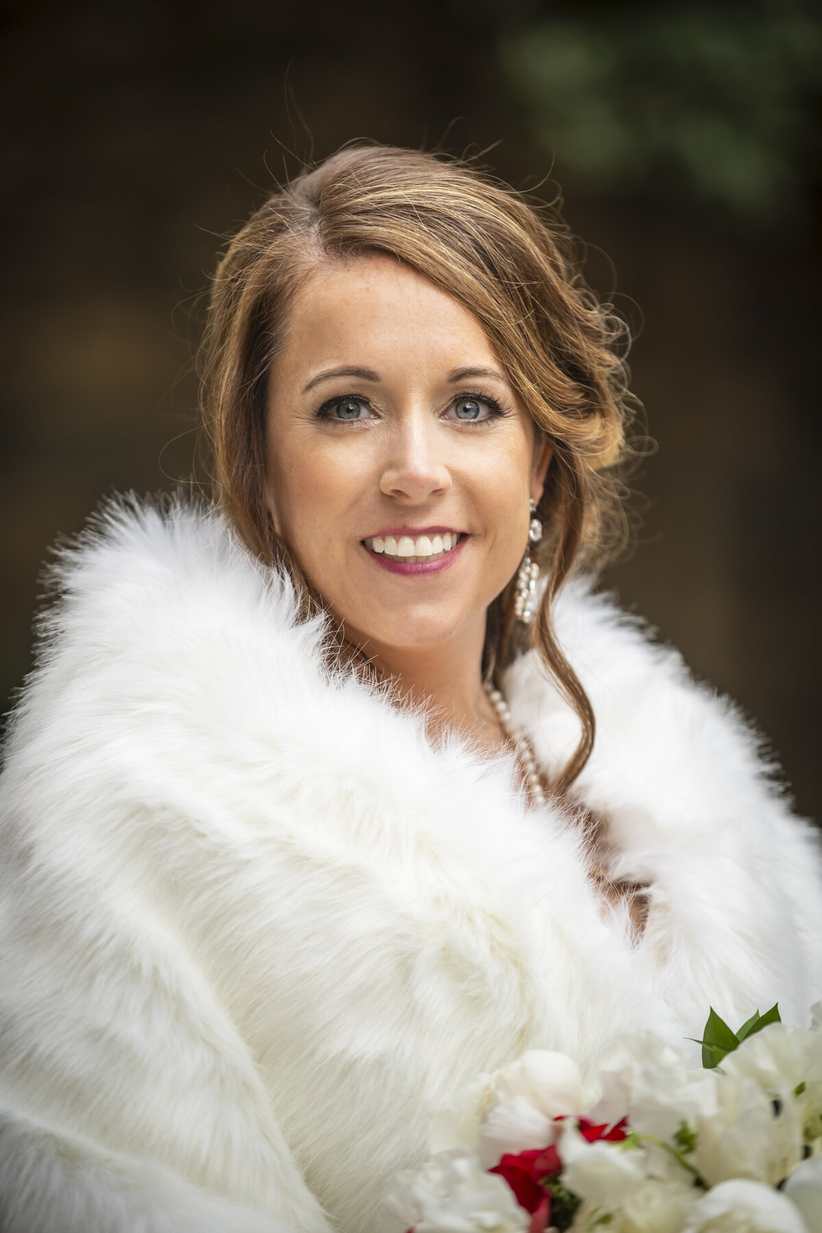 Bride wearing luxury fur while smiling.