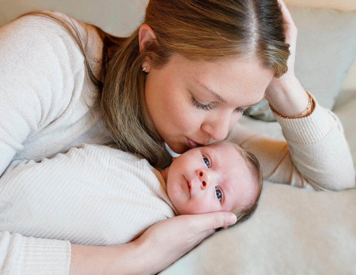 denver newborn photography - woman kissing baby's head