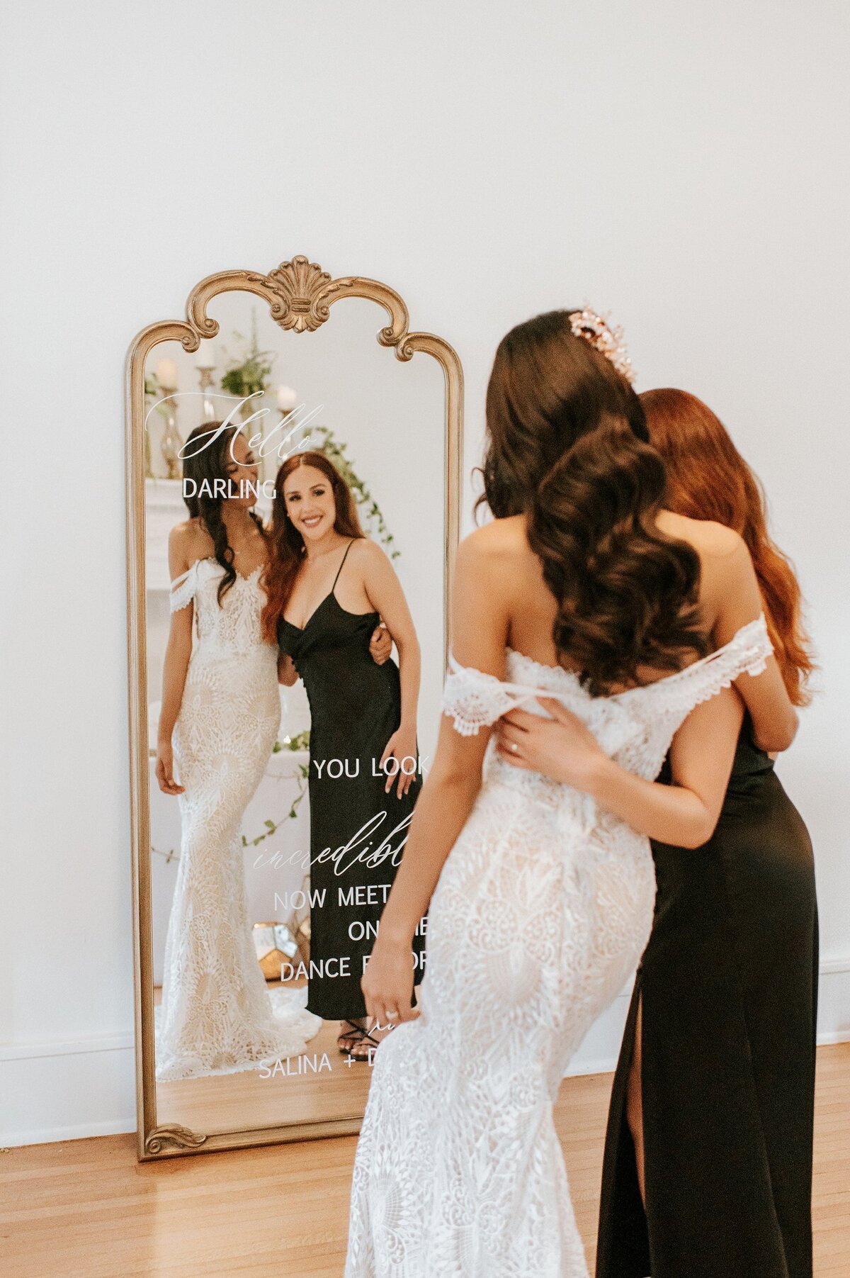 Large gold wood mirror with ornate arches at the top and calligraphy for a selfie sign