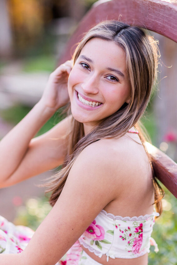 teen girl leaning against bridge