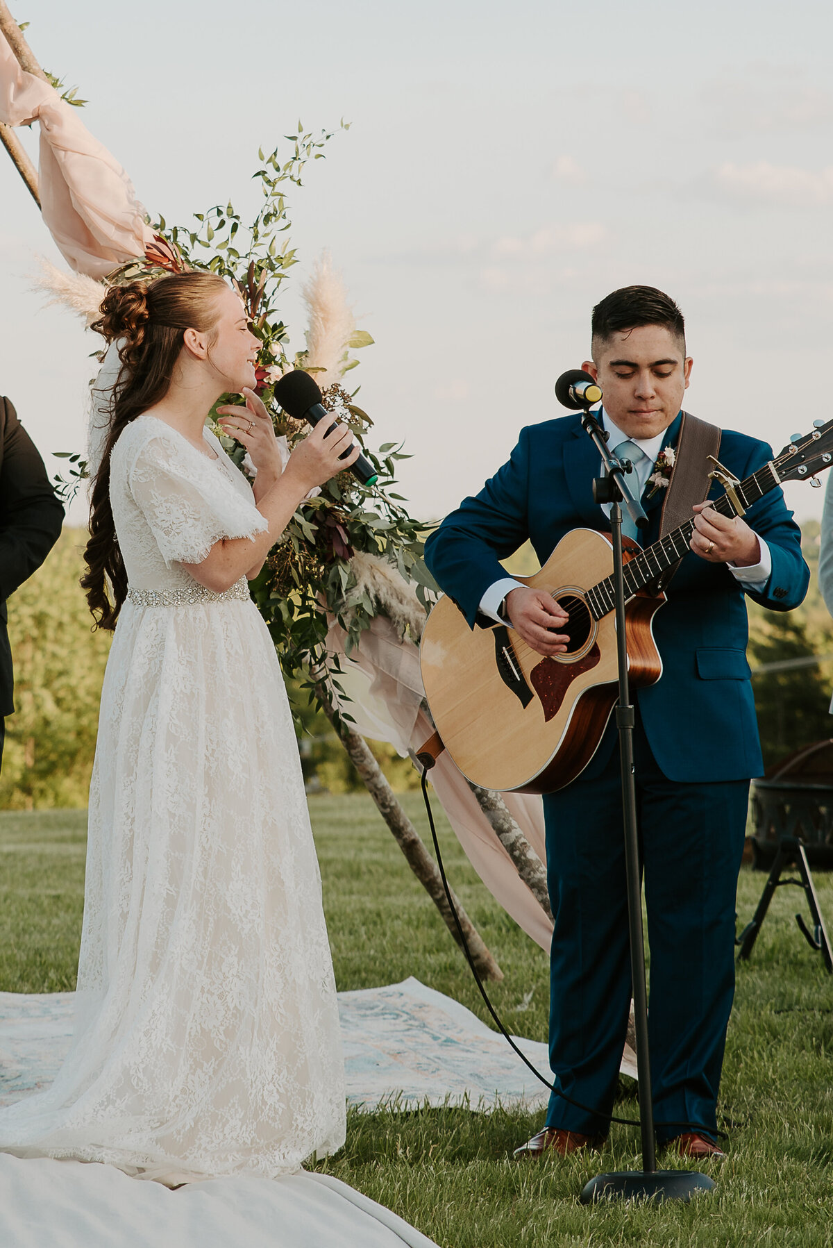 Intimate wedding in the mountains of North Carolina, bride and groom playing a song together at the ceremony.
